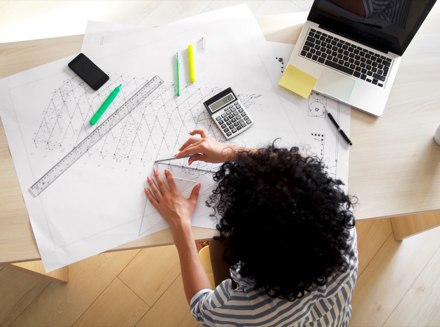 Architect reviewing plans and cost calculations