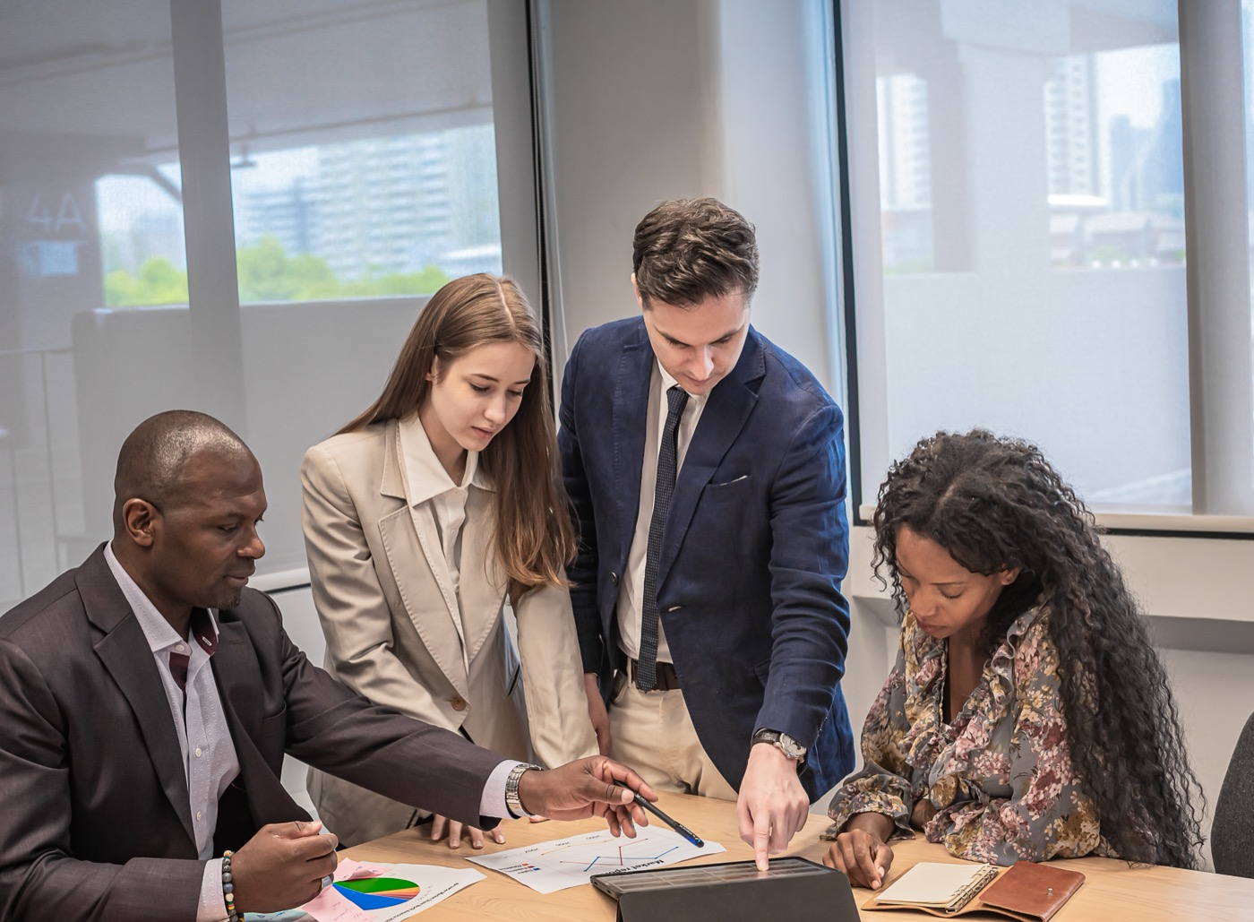 Business team reviewing project data on a tablet