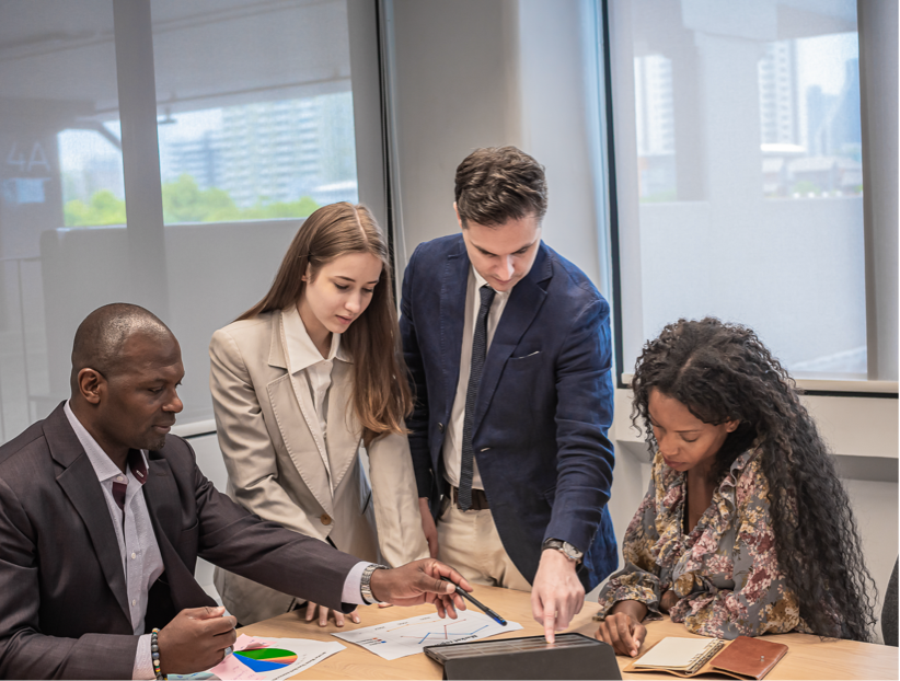 Colleagues reviewing project risk documents together in an office